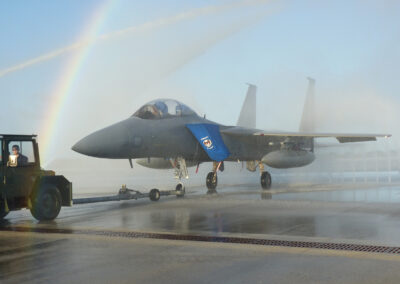 Close up of military aircraft being rinsed with the clear water rinse system with a rainbow in the background