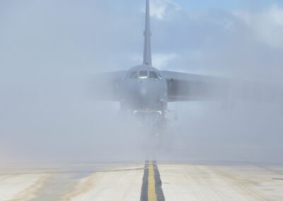 Front view of the clear water rinse system rinsing a military aircraft
