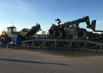 Two construction vehicles loading into the vehicle wash system