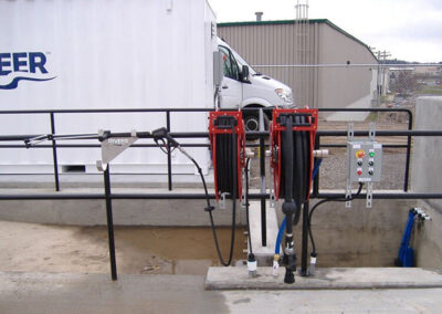 In-ground wash system pad hose holder