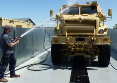 Close up front angle of person washing military tank