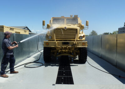 Front angle of person washing military tank