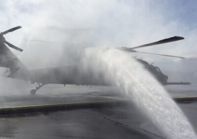 Water spraying on helicopter from tactical rinse system