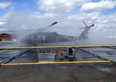 Tactical rinse system side view of helicopter being washed