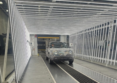 Camo wrapped car inside rain testing equipment