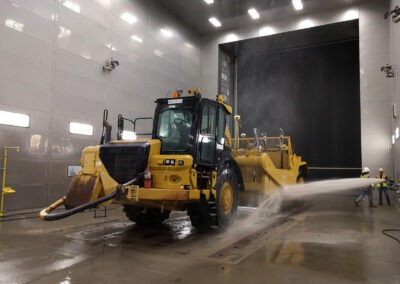Heavy Equipment in a custom wash bay being sprayed by a high volume water cannon